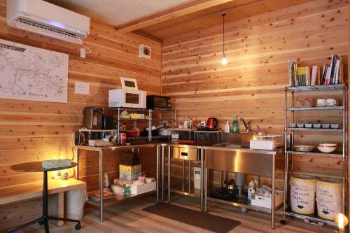 a kitchen with wooden walls and a counter in a room at RIVIERA Iya Valley in Akano