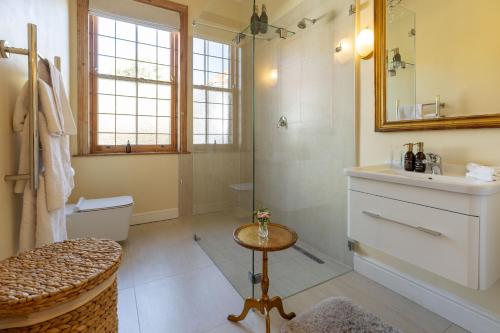 a bathroom with a shower and a sink and a toilet at Villa Puccini in Cape Town