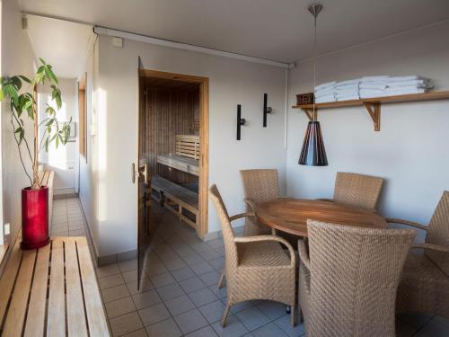 a dining room with a wooden table and chairs at Best Western Malmia Hotel in Skellefteå