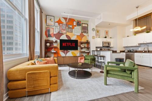 a living room with a couch and a table at Indy City Views - Walk to Stadium - Convention Center - Arcades - Sleeps 8 - Gym in Indianapolis