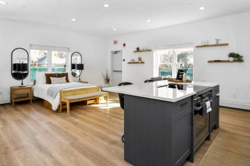 a bedroom with a bed and a kitchen with a stove at Harbor Haven, Apt #1 - Studio in Stamford