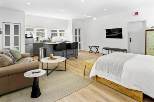 a bedroom with a bed and a couch and a kitchen at Harbor Haven, Apt #1 - Studio in Stamford