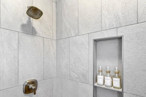 una ducha con tres botellas de alcohol en un estante en Harbor Haven, Apt #1 Studio, en South End