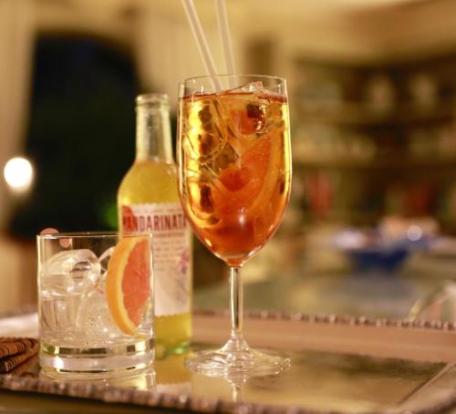 a drink in a wine glass next to a bottle at Villa Agnese in Sestri Levante