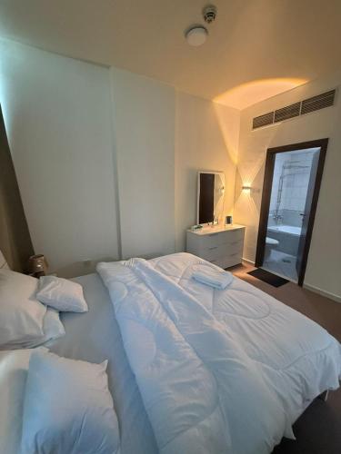 a large white bed in a room with a window at Suite one bedroom apartment Down town abudhabi in Abu Dhabi