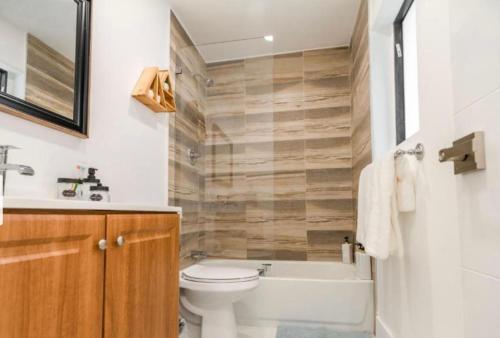 a bathroom with a toilet and a tub and a sink at Viva La Villa in Highland Lakes