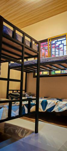 a group of bunk beds in a room at Lolo's Staycation in Tinajeros