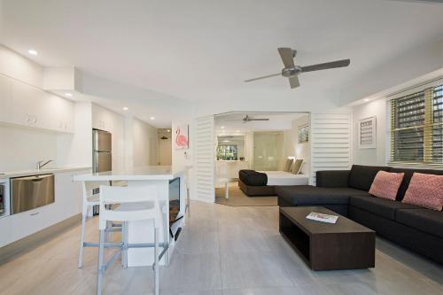 a living room with a couch and a table at Mantra French Quarter Noosa in Noosa Heads