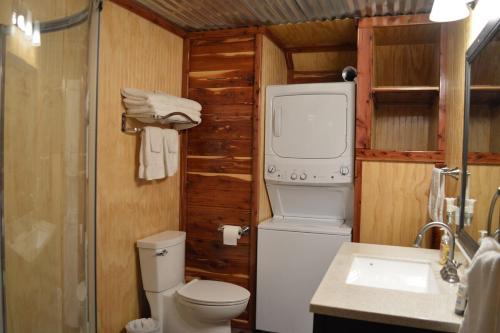 a small bathroom with a toilet and a sink at Secluded Getaway on a Vineyard in Allen, Oklahoma in Allen