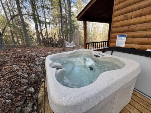 a bath tub in a cabin in the woods at WiFi & Pet Friendly - The Road's End in Rogers