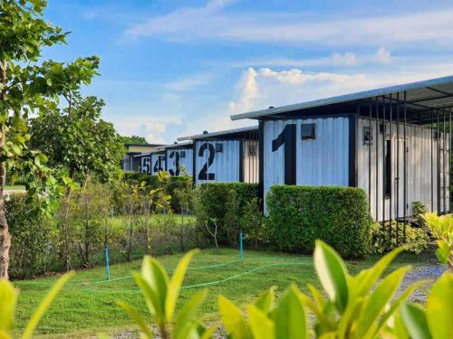 a building with numbers on the side of it at Boxotel in Ban Nong Chik