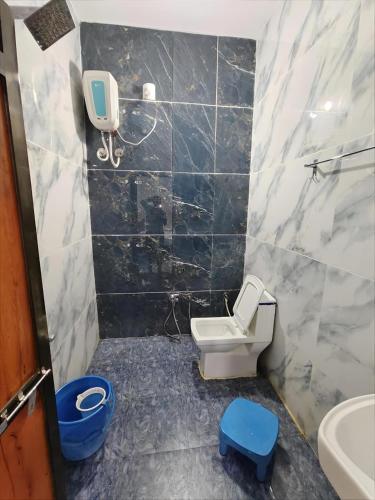 a small bathroom with a toilet and a sink at Hotel DIVYA DARSHAN in Ujjain