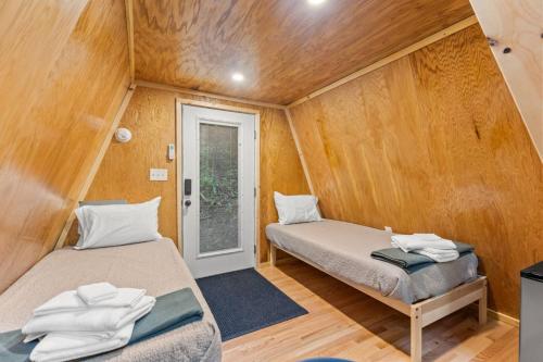 a room with two beds in a tiny house at The Overlook - Camping Cabin Retreat in RRG KY in Rogers