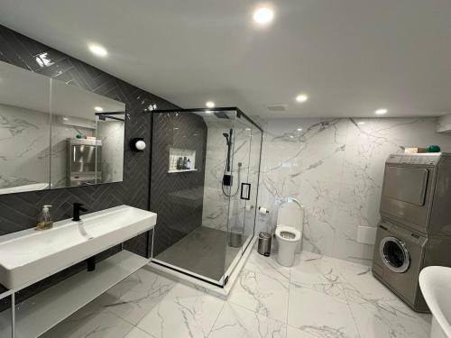 a bathroom with a sink and a shower at Aqua Luxury House on the Shore in Laval