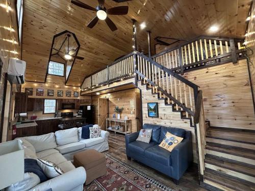 a living room with a staircase in a cabin at WiFi & Hot Tub Large Family - Climb On in RRG in Rogers