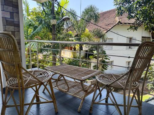 two chairs and a table on a balcony at Kochi Bella Villa in Cochin