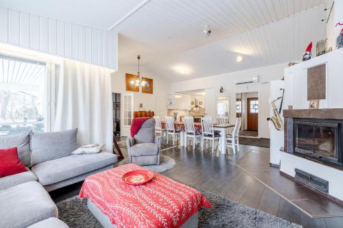 a living room with a couch and a fireplace at Rovaniemi Riverside Family House near Santa Claus Village - Sauna & Aurora View in Rovaniemi