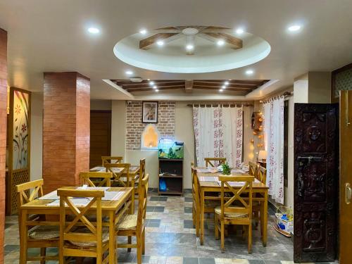 a dining room with wooden tables and chairs at Hotel Vacation Home Kathmandu - Thamel in Kathmandu