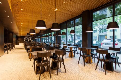 a row of tables and chairs in a restaurant at Quentin Berlin Hotel am Kurfürstendamm in Berlin