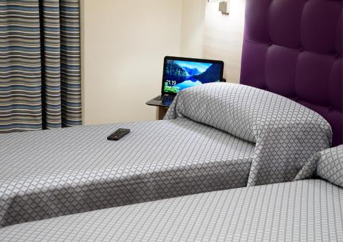 a bedroom with a bed and a laptop on a table at Hotel Torino Porta Susa in Turin