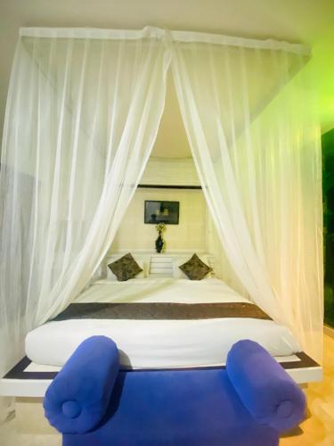 a bedroom with a bed with a canopy at Private Pool Classic Villa in Kuta