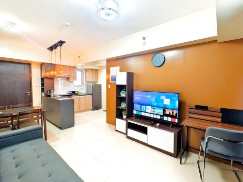 a living room with a tv and a kitchen at 1618T3 Avida Riala IT Park 1BR Unit in Cebu City