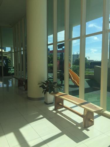 a wooden bench in the middle of a building at Afiniti Residensi Legoland Medini in Nusajaya