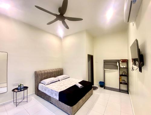 a bedroom with a bed and a ceiling fan at AZ Roomstay Pendang in Pendang