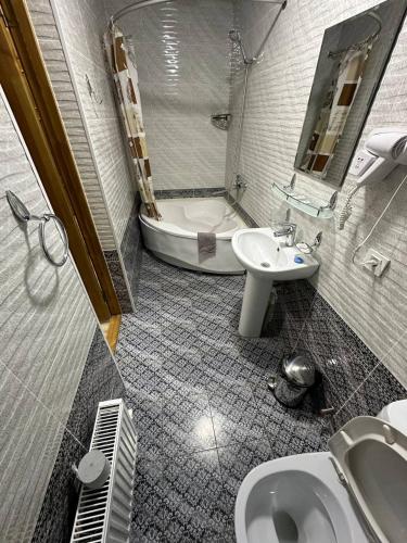 a bathroom with a sink and a toilet and a tub at NABIBEK TERRACE Ponorama view old city in Bukhara
