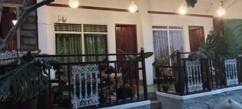 a house with a black fence and some plants at Talblick Valley in Ella