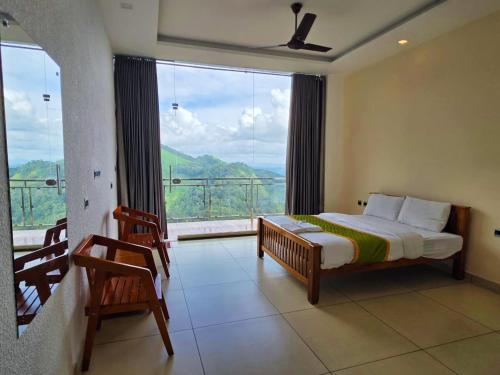 a bedroom with a bed and a large window at Misty Ville Homestay in Munnar