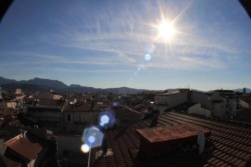 a view of a city with the sun in the sky at Hotel Mirage in Viareggio