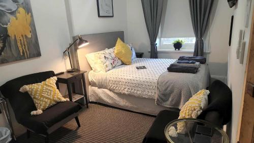 a small bedroom with a bed and a chair at Magpie and Stump Hotel 'Nest Accommodation' in Mintaro