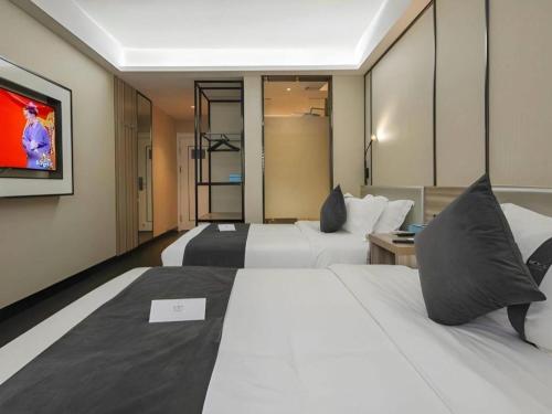 Postel nebo postele na pokoji v ubytování Xana Lite Beijing Shunyi Metro Station