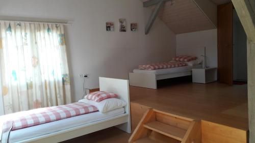 a room with two beds in it with a window at Good Bed Reiden in Reiden