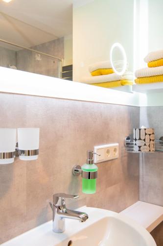a bathroom with a sink and a mirror at Fewo Märzenberg in Zella-Mehlis