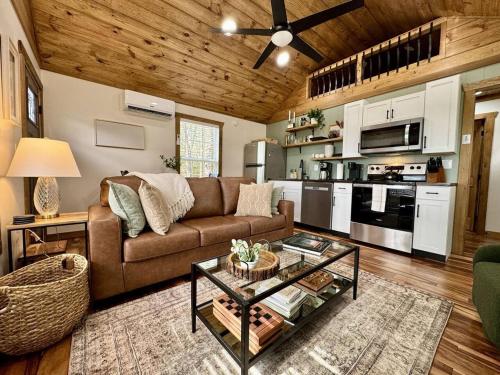 a living room with a couch and a table at Alone At Last - New LUX - WiFi - Hot Tub in High Falls