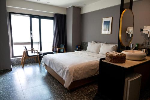 a bedroom with a bed and a sink and a mirror at hotel No25 in Incheon