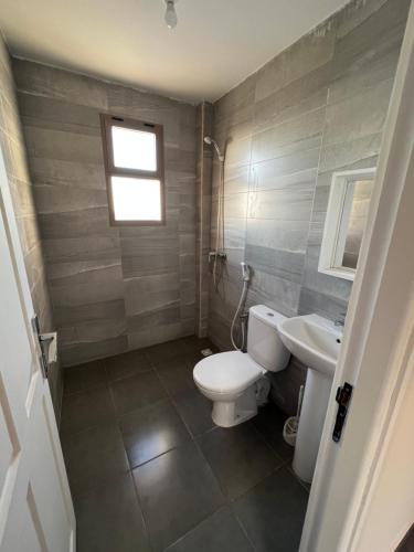 a bathroom with a toilet and a sink at Tazgha house in Essaouira