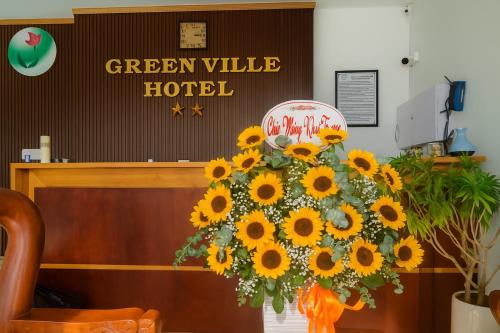a bouquet of sunflowers in front of a hotel at Green Ville Hotel Đồng Nai in Xa Dau Giay