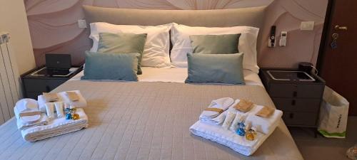 a bedroom with a large bed with two baskets on it at Casa Nova Garden in Arsago Seprio