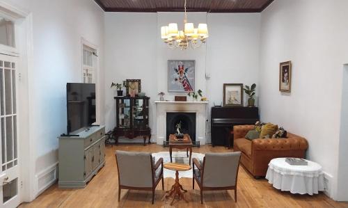 a living room with a couch and a fireplace at Karoo Sunset Villa in Richmond