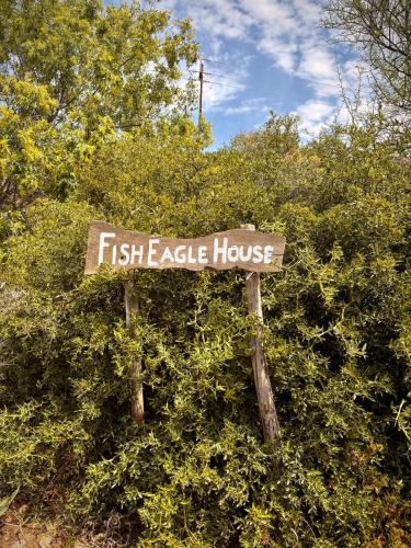 a sign that says first eagle house in a bush at Fish Eagle House on the Dam in Montagu