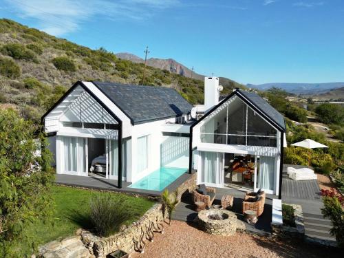 a black and white house with a swimming pool at Fish Eagle House on the Dam in Montagu