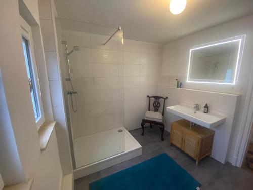 a bathroom with a shower and a sink and a tub at Gästewohnung Augsburg - Spickel in Augsburg