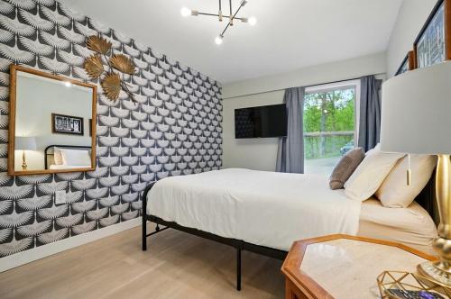 a bedroom with a bed and a mirror at Carriage House Retreat 1 in Milford