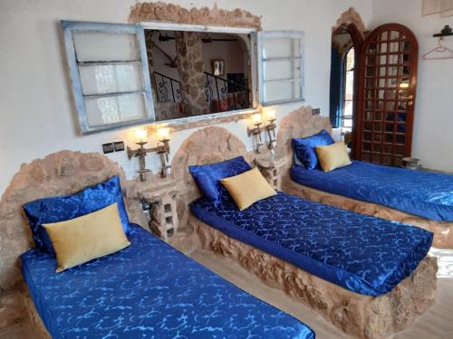 a room with three blue couches and a mirror at Authentic Guesthouse with Garden and Mountain View Beni Mellal in Beni Mellal