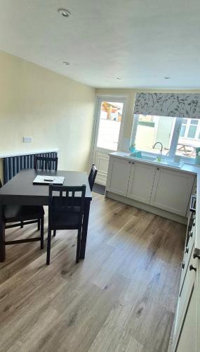 a kitchen and dining room with a table and a sink at Amaryllis Escapes in Brecon