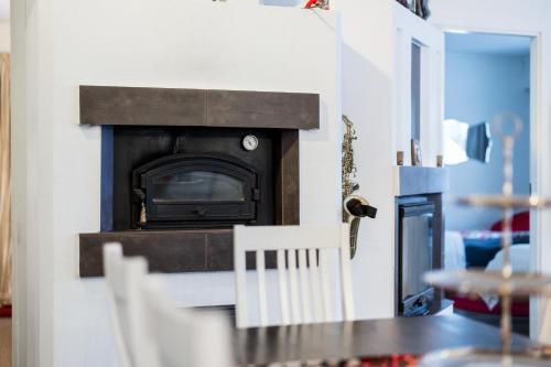 a living room with a fireplace in a doll house at Rovaniemi Riverside Family House near Santa Claus Village - Sauna & Aurora View in Rovaniemi