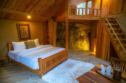 a bedroom with a large bed in a cabin at Doghari Chalets Jibhi by Himtrek Stays in Jibhi
